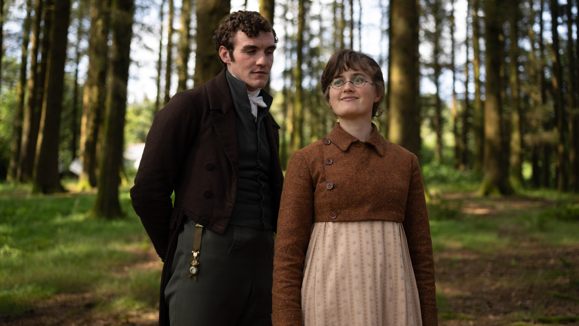 Mary Bennet (ELLA BRUCCOLERI) and Mr Hayward (D&Oacute;NAL FINN) stand in a forest, in 'The Other Bennet Sister.'