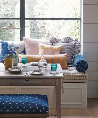 A kitchen banquet with brightly colored cushions