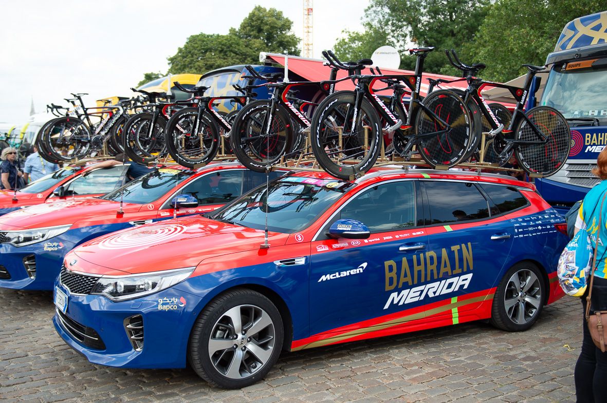 Spare bikes sit easily accessiblee on top of the Bahrain Merida team cars