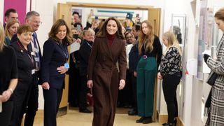 Catherine, Princess of Wales walks down a corridor as people watch during a visit to The Royal Marsden Hospital on January 14, 2025