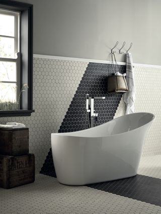 black and white bathroom with hexagon tiles, white tub