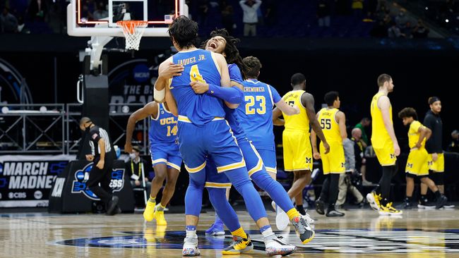 Tyger Campbell #10 of the UCLA Bruins celebrates with Jaime Jaquez Jr. #4 after defeating the Michigan Wolverines 51-49 in the Elite Eight round game of the 2021 NCAA Men&#039;s Basketball Tournament at Lucas Oil Stadium on March 30, 2021 in Indianapolis, Indiana.