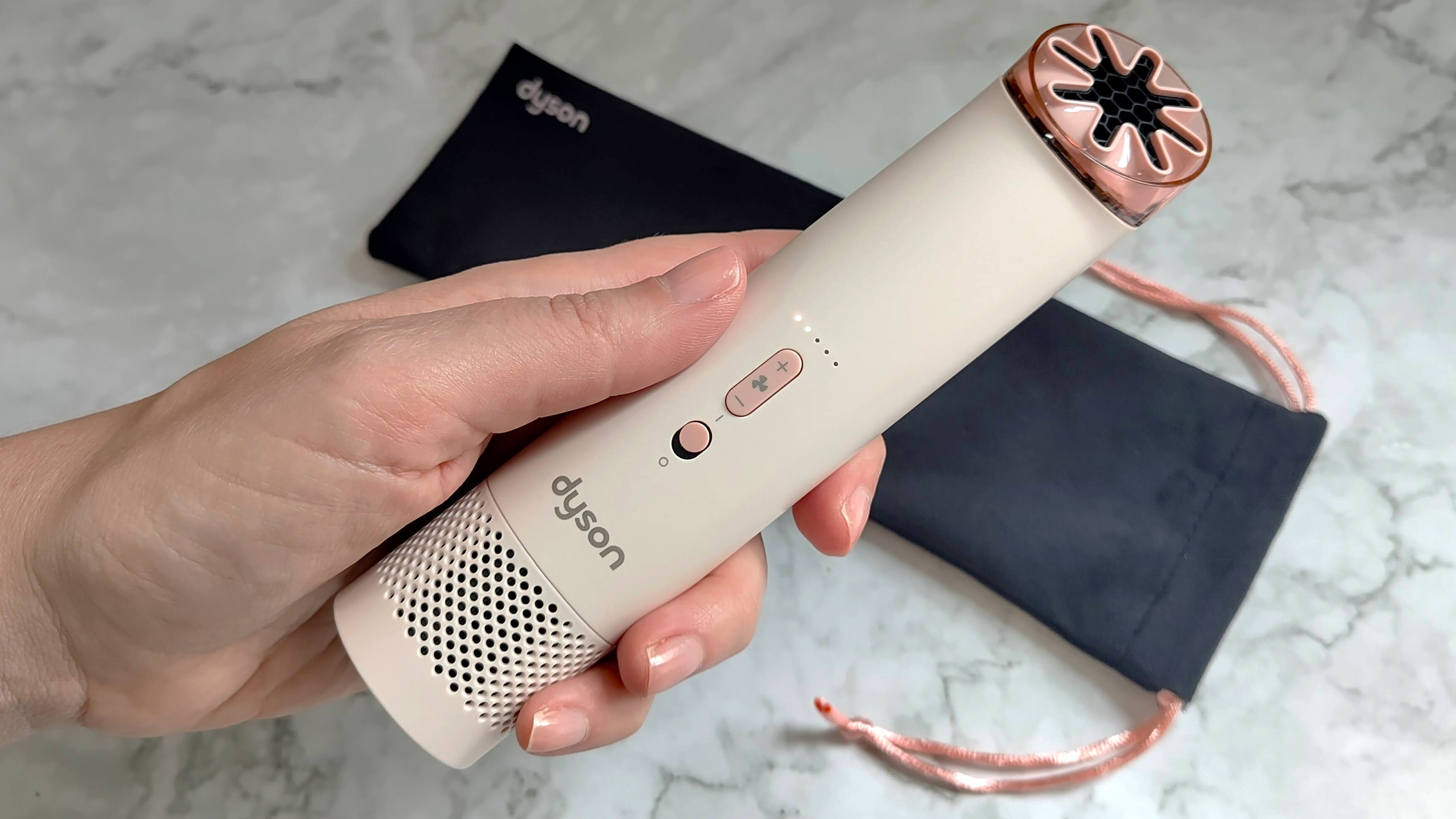 Dyson HushJet Mini Cool fan in woman's hand