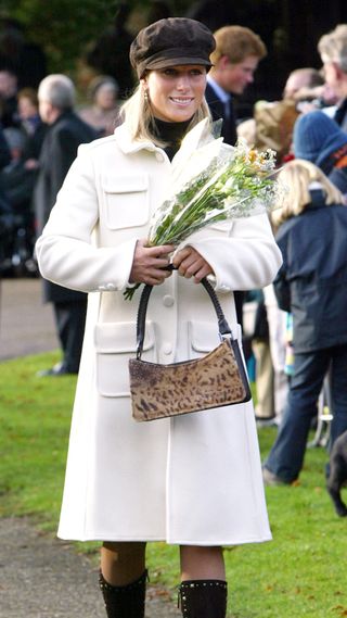 Zara Tindall holds a bag and a bunch of flowers on Christmas Day in 2003