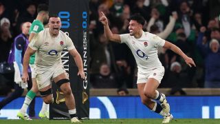 Marcus Smith of England celebrates scoring the winning drop goal with teammates during the Guinness Six Nations 2024 match between England and Ireland