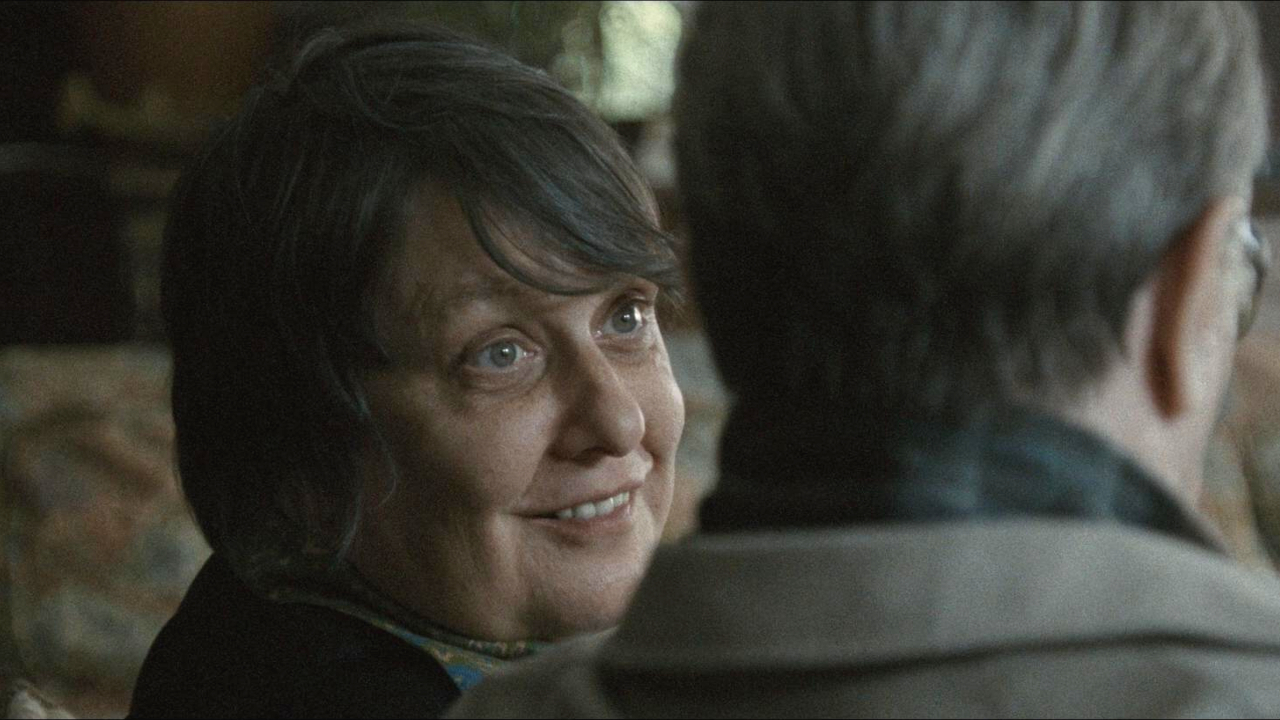 Kathy Burke smiles as she sits next to Gary Oldman in Tinker Tailor Soldier Spy.