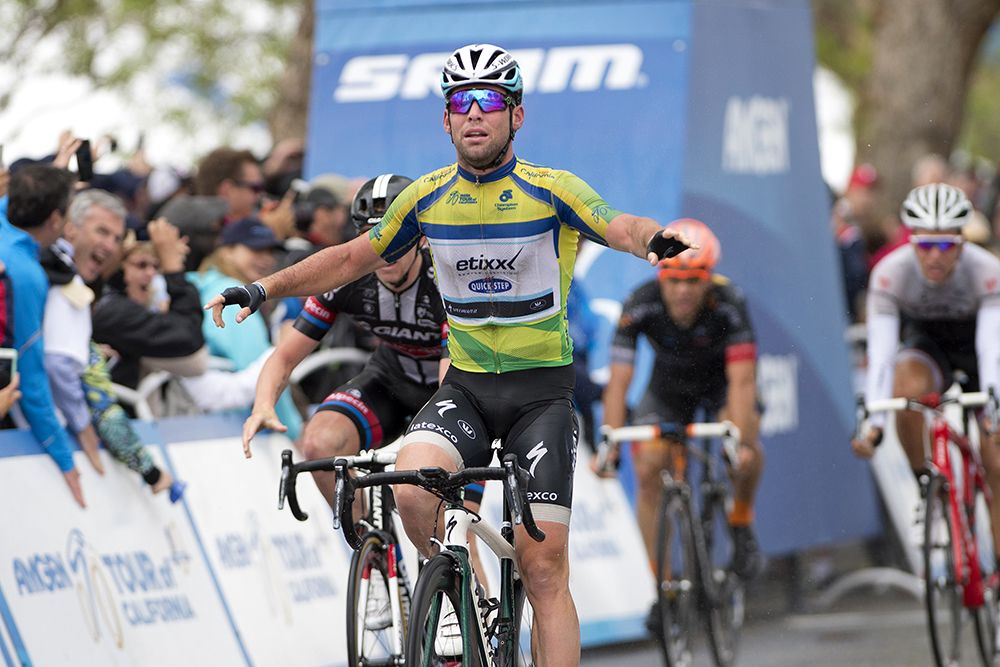 Mark Cavendish (Etixx-Quick Step) begins to celebrate a wet victory