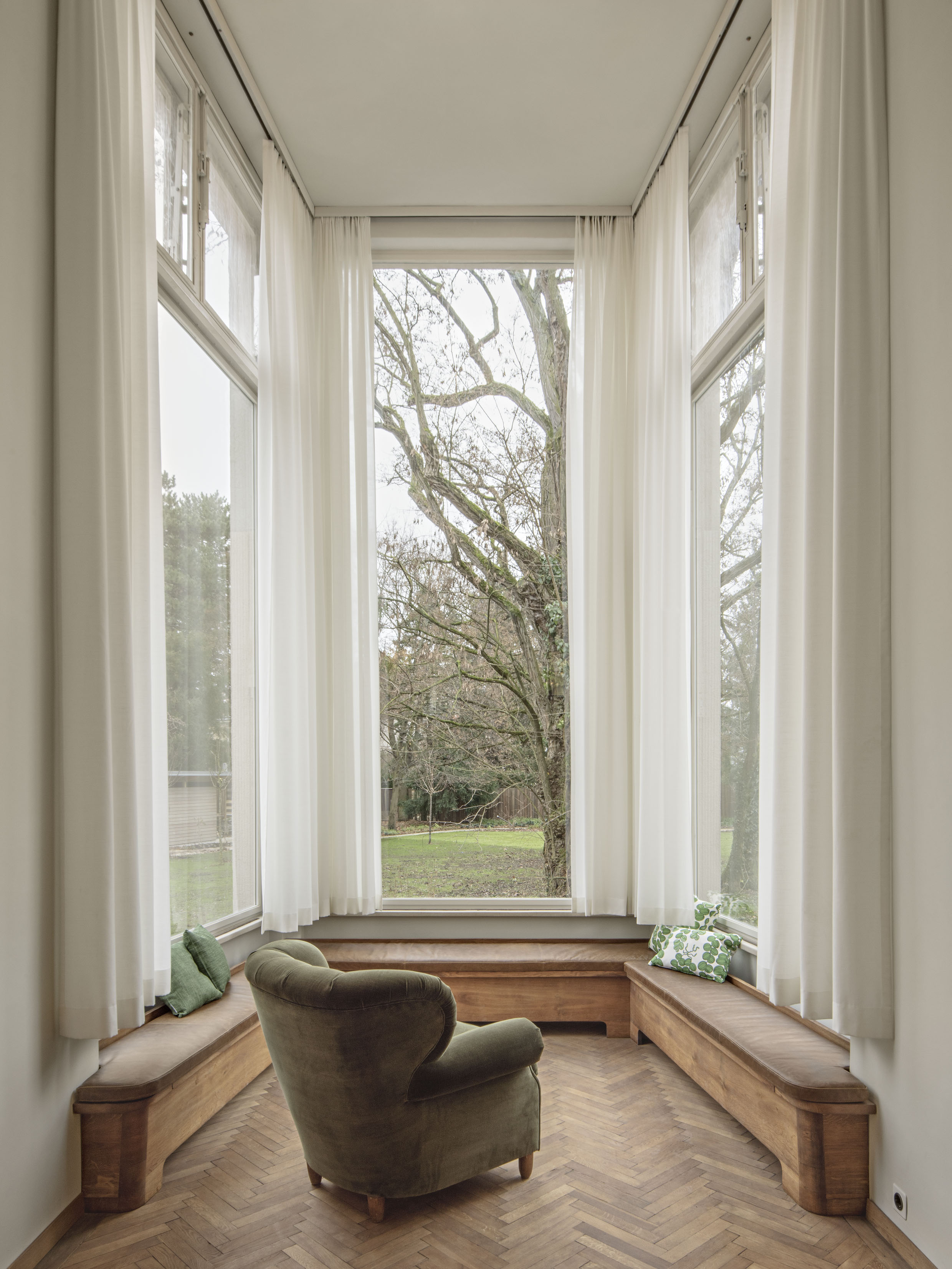 interiors of Villa Beer showing the house restored and clean, sparsely furnished showing off white walls and key furniture pieces