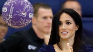 Meghan Markle looking pensively at a netball