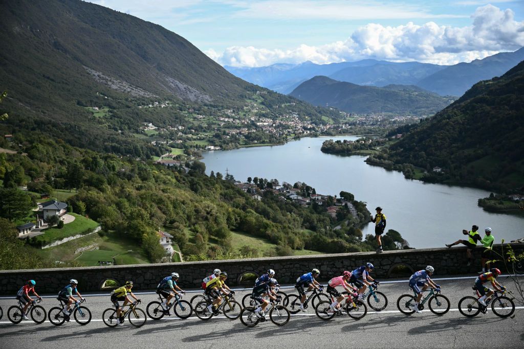 The pack of riders (peloton) cycles in the ascent of Forcellino Di Bianzano, near Lago di Endine lake, during the 118th edition of the Giro di Lombardia (Tour of Lombardy), a 252km cycling race from Bergamo to Como on October 12, 2024. (Photo by Marco BERTORELLO / AFP)