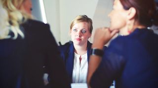 Two HR people interviewing a woman