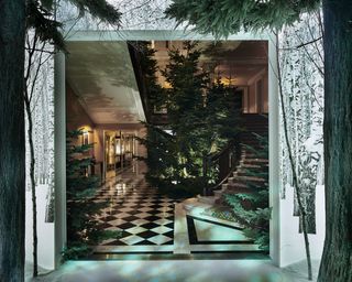 Interior design of Claridge's showing large Christmas trees and staircase