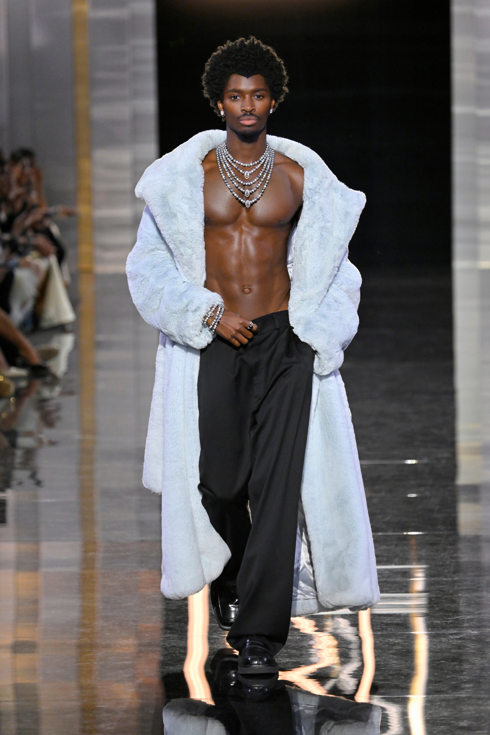 model walking with stacked diamond necklaces