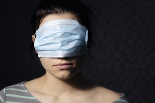 Woman wearing her mask on her eyes.