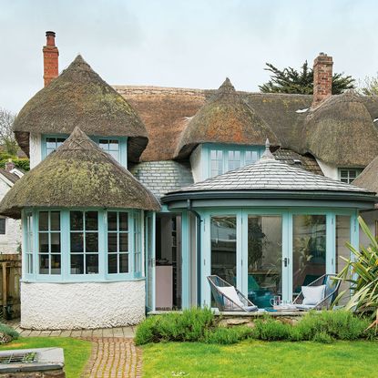 Exterior of house with garden and blue window frames