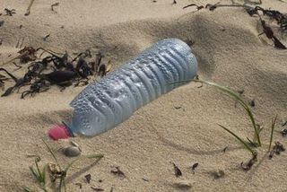 Close up on a plastic bottle left on a beach