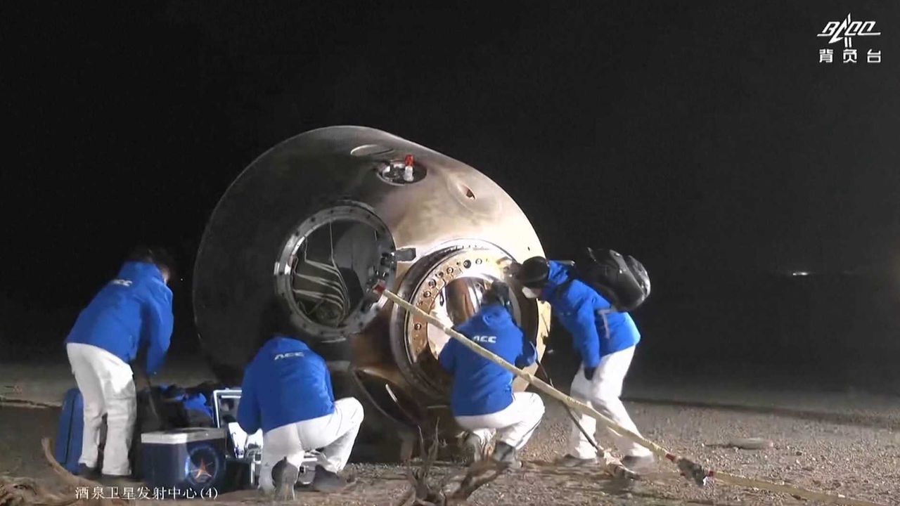 The Shenzhou 14 crew capsule is seen on its side after landing to return three astronauts to Earth on Dec. 4, 2022 in the Dongfeng Landing field in Fuyang city, Anhui province, China.
