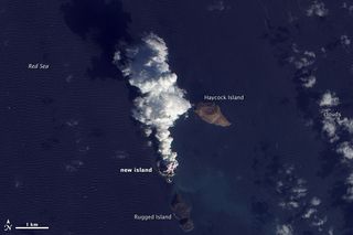 A plume rises from a new island in the Red Sea on Dec. 23, 2011. 