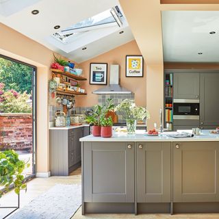 Peach kitchen with grey cabinetry with extension including skylights and bifolds