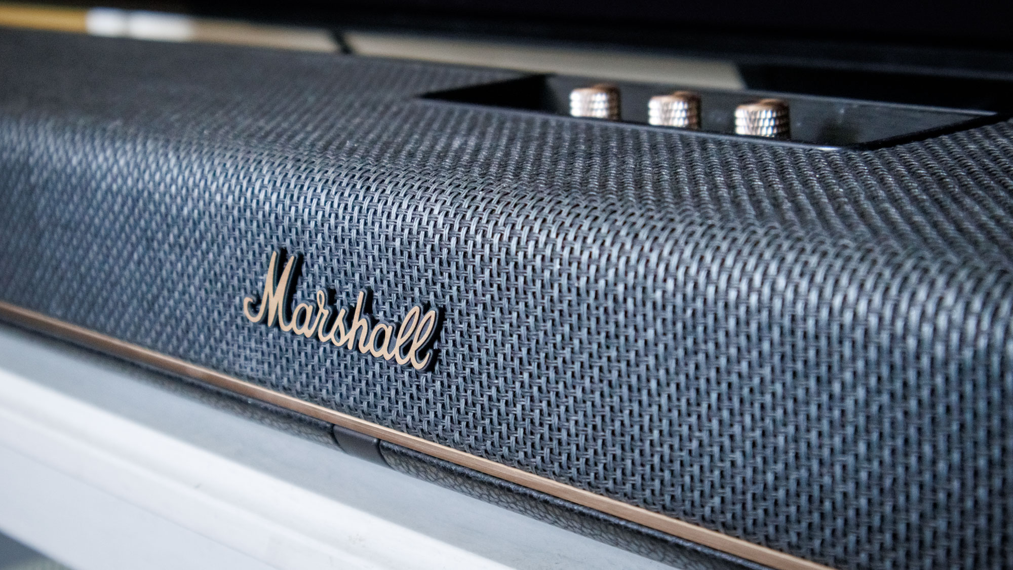 A Marshall Heston 120 soundbar on a TV stand.