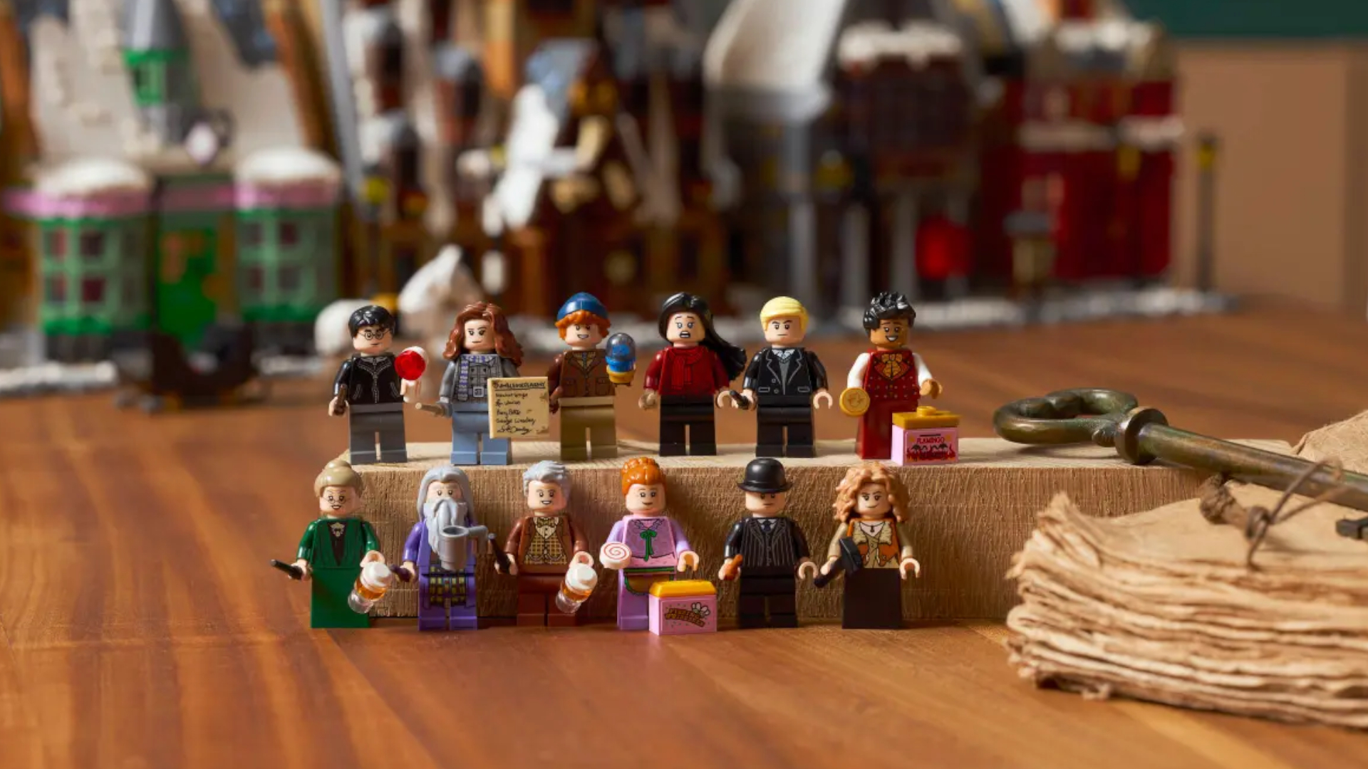 The Lego Hogsmeade Village - Collectors' Edition set minifigures lines up on a wooden surface