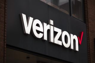 Verizon logo in white and red lettering on a black billboard