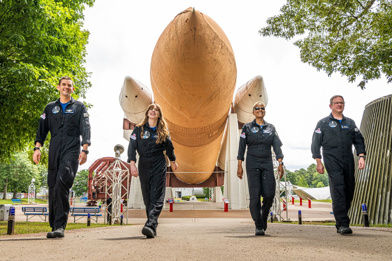 SpaceX's Inspiration4 crew pose with a a NASA space shuttle mockup at the U.S. Space and Rocket Center in Huntsville, Alabama.