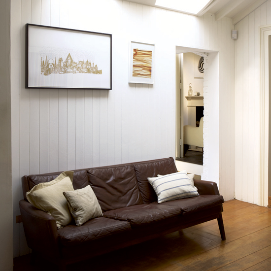 living room with wooden flooring and sofaaset with cushions