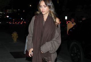 Jessica Alba in a brown sweater and satin skirt