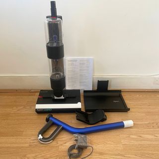 Components of the Dyson WashG1 sitting on hardwood floor