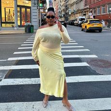 @aniyahmorinia walking down the street wearing yellow top and yellow skirt