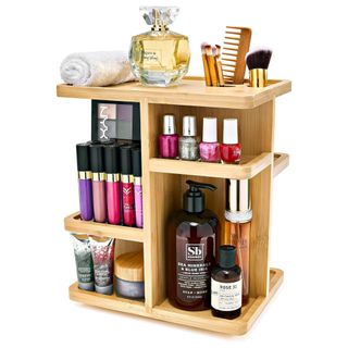 A brown bamboo revolving organizer filled with cosmetics