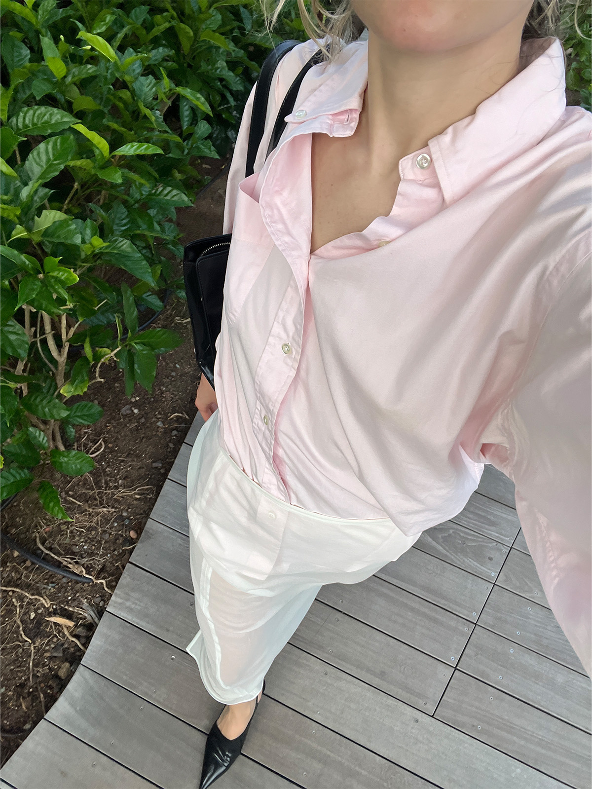 Eliza Huber wearing a pink button-down shirt and sheer white skirt.