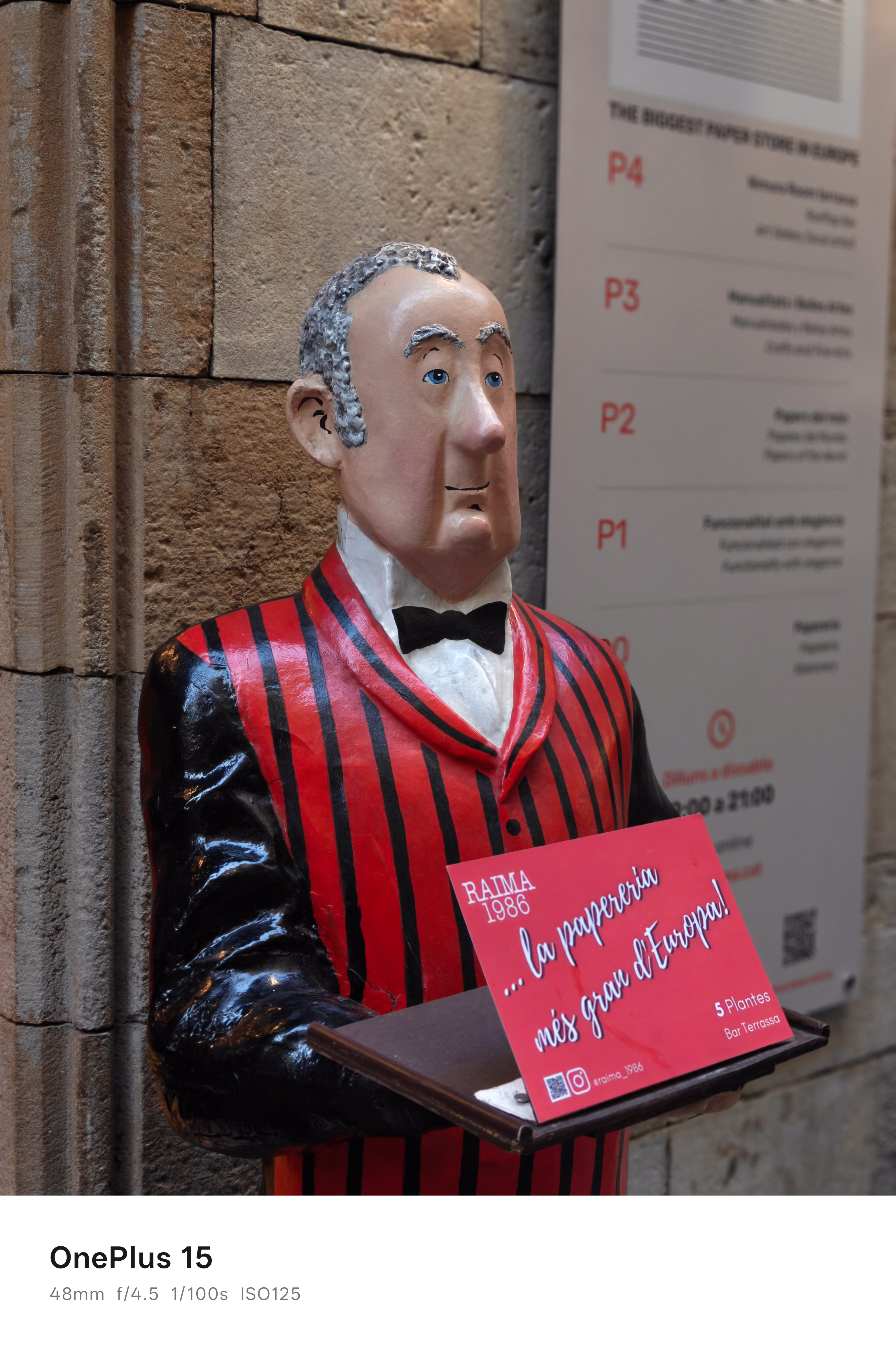 A statue of a waiter outside a restaurant