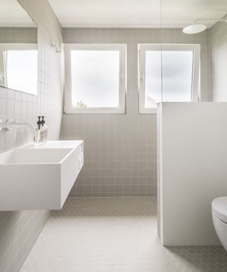 Bathroom with mixed gray tiles and white sink