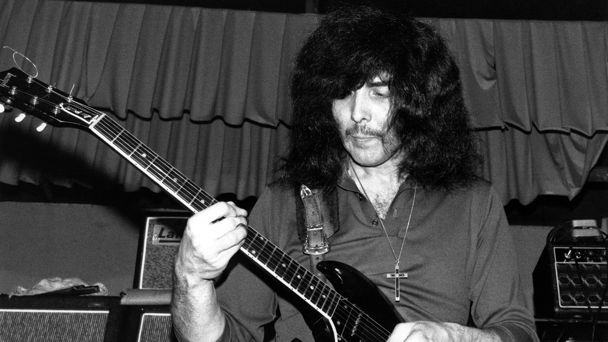 Tony Iommi performing on stage in Earth, the predecessor to Black Sabbath