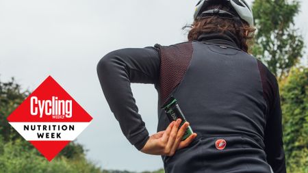 Female cyclist grabbing an energy bar out of her jersey pocket