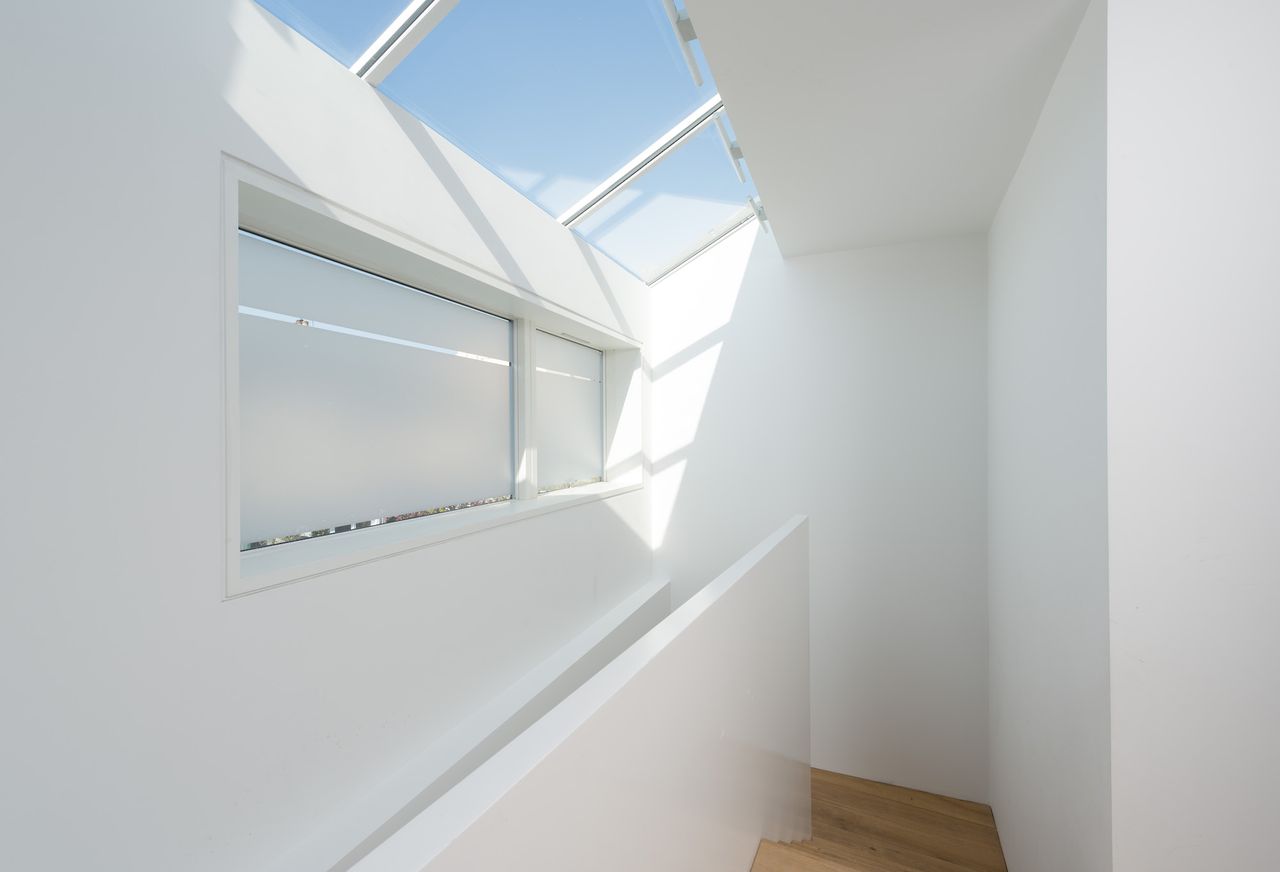 white landing above staircase with rooflights