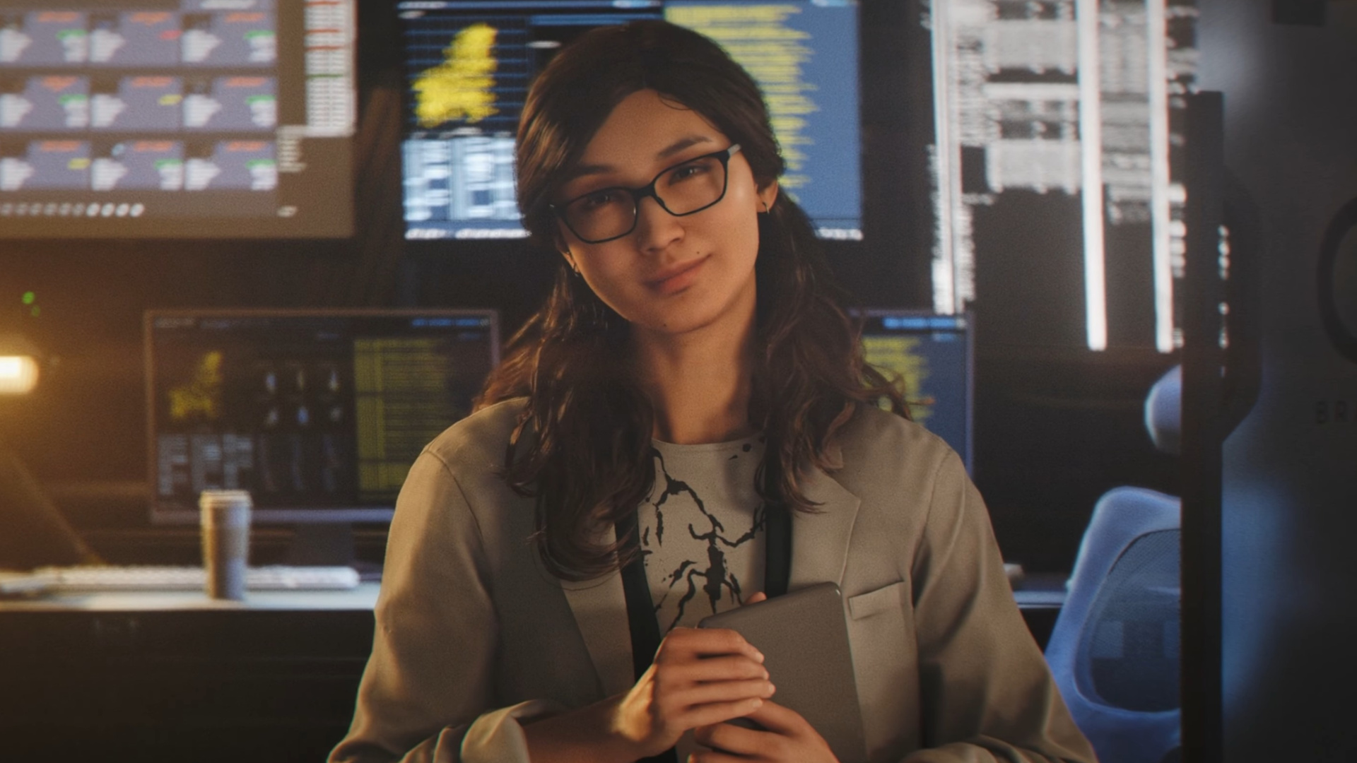 Selina Tan, from Q-Branch and wearing a lab coat, stands in front of a bank of computers 007 First Light