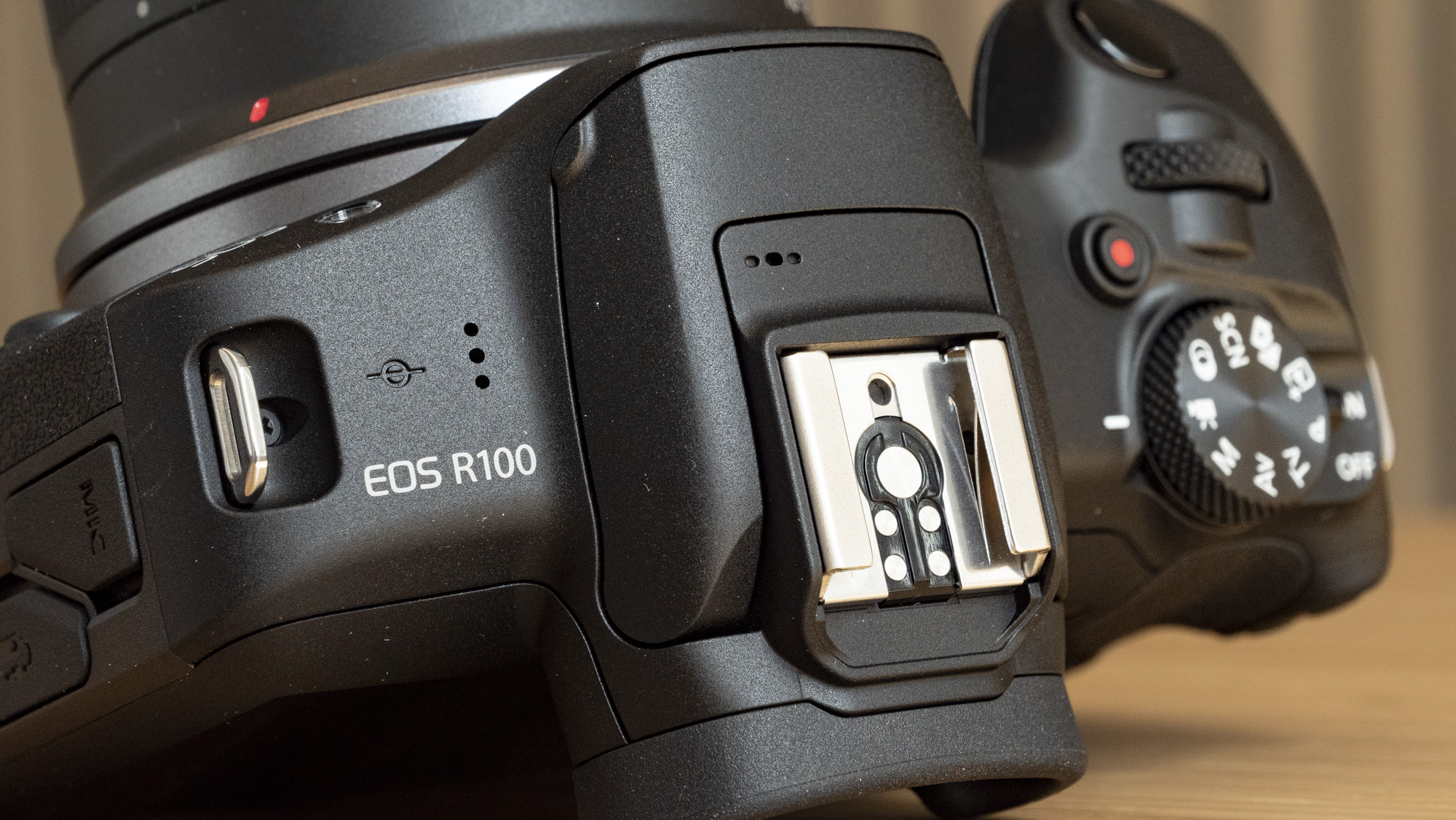 Canon EOS R100 camera on a table closeup of hotshoe