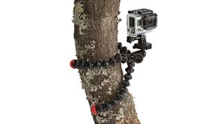 Joby GorillaPod Action Tripod shown gripping a tree trunk on a white background