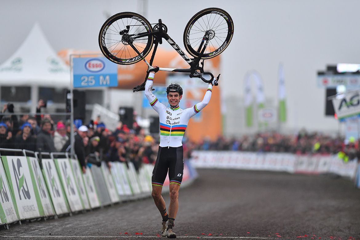 Wout Van Aert lifts his bike over his head