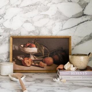 A still life painting in a white marble kitchen