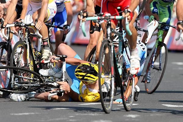 Schumacher's team-mate Bernhard Kohl then falls on top of him.