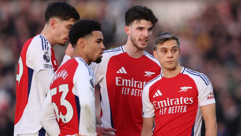 Four Arsenal players gather together during a Premier League game