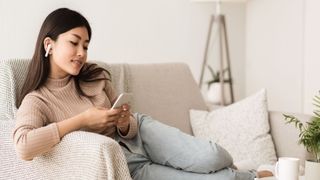 Girl in Airpods Listening Music Online on Smartphone