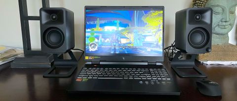 Acer Nitro 16 AMD on a desk playing a PC game