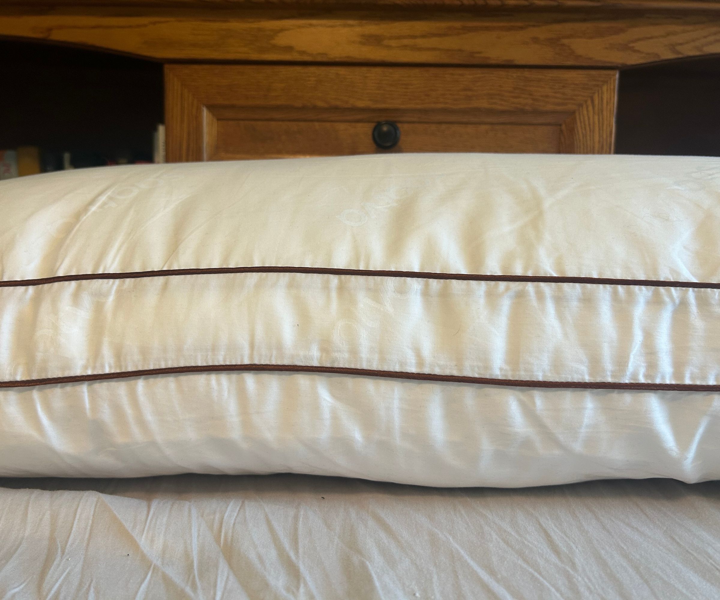 Images of the Saatva Latex pillow close up and from the side to demonstrate testing for a review