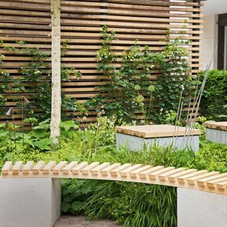 garden area with slated bench and blond wood with coffee table