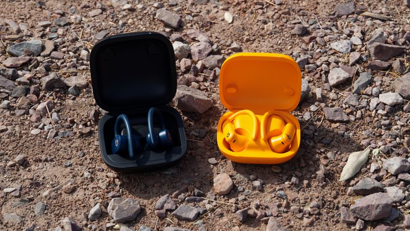 The orange Powerbeats Pro 2 next to the Navy original Powerbeats Pro.